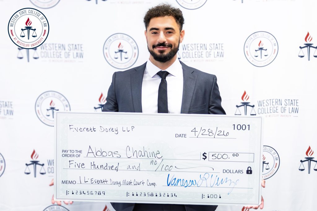 Abbas Chahine with his check after winning the Moot Court Competition