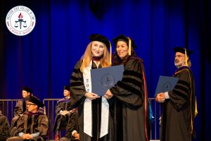 Student with Dean at commencement ceremony.