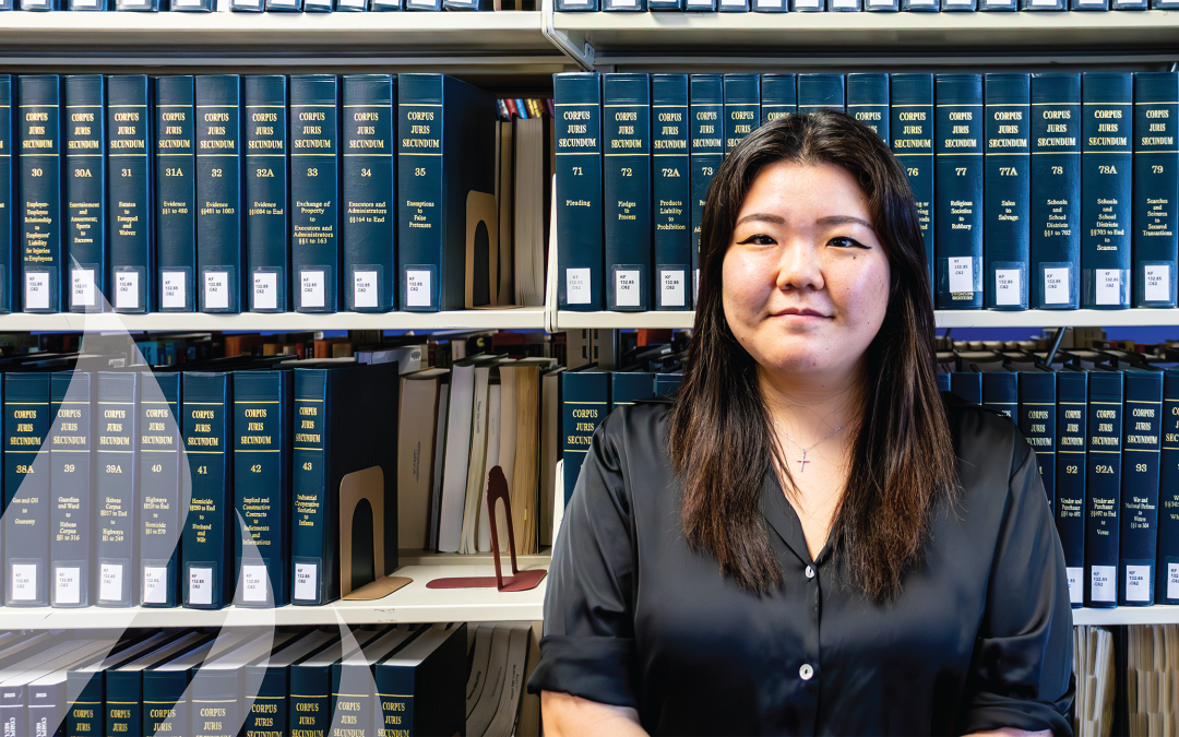 Joyce Kim in front of a bookshelf.