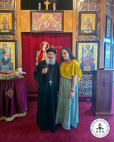 Lydia Shahid with priest in church