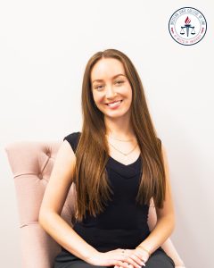 Noelle Nourafshan in a pink chair.