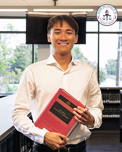 Ryan Trieu holding a book