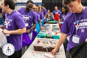 Students assembling backpacks.